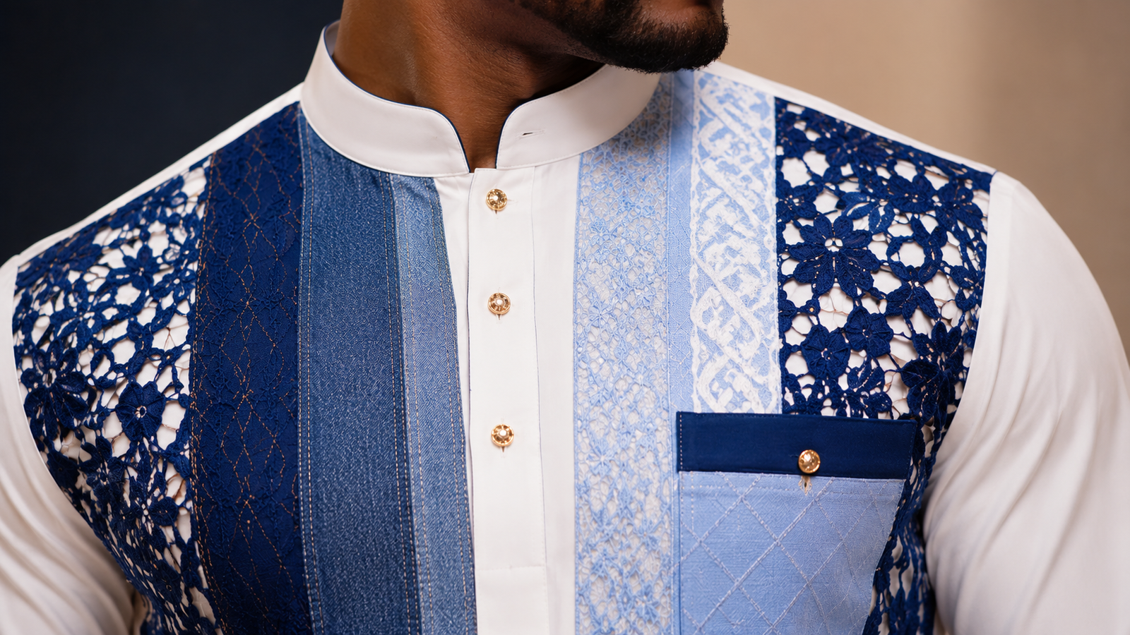 Close-up of royal blue lace embroidery on white men's designer top with premium tailoring